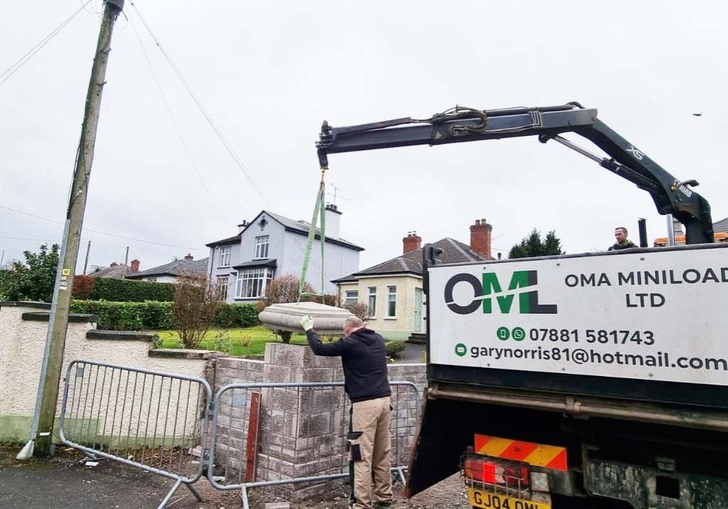 Placing cap stone on pillar in Omagh